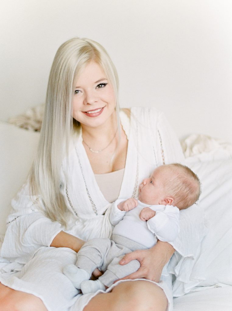 woman with long blonde hair with her newborn boy