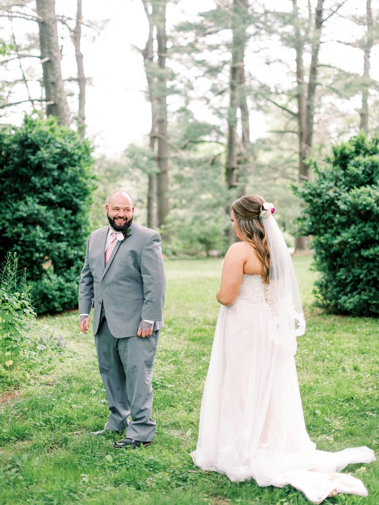 first look of a bride and groom at their wedding at the Greencloft Club in Charlottesville VA