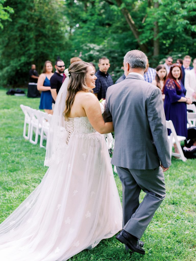 father walks his daughter down the aisle at the Greencloft Club in Charlottesville VA